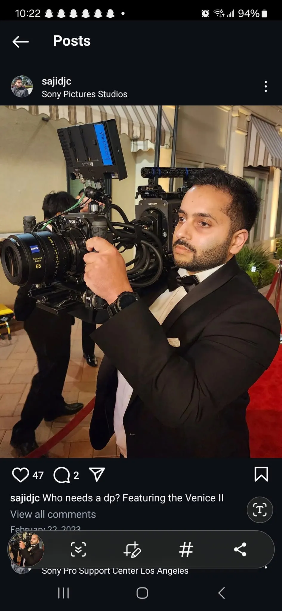 Camera operator holding a Sony cinema camera on a red carpet set