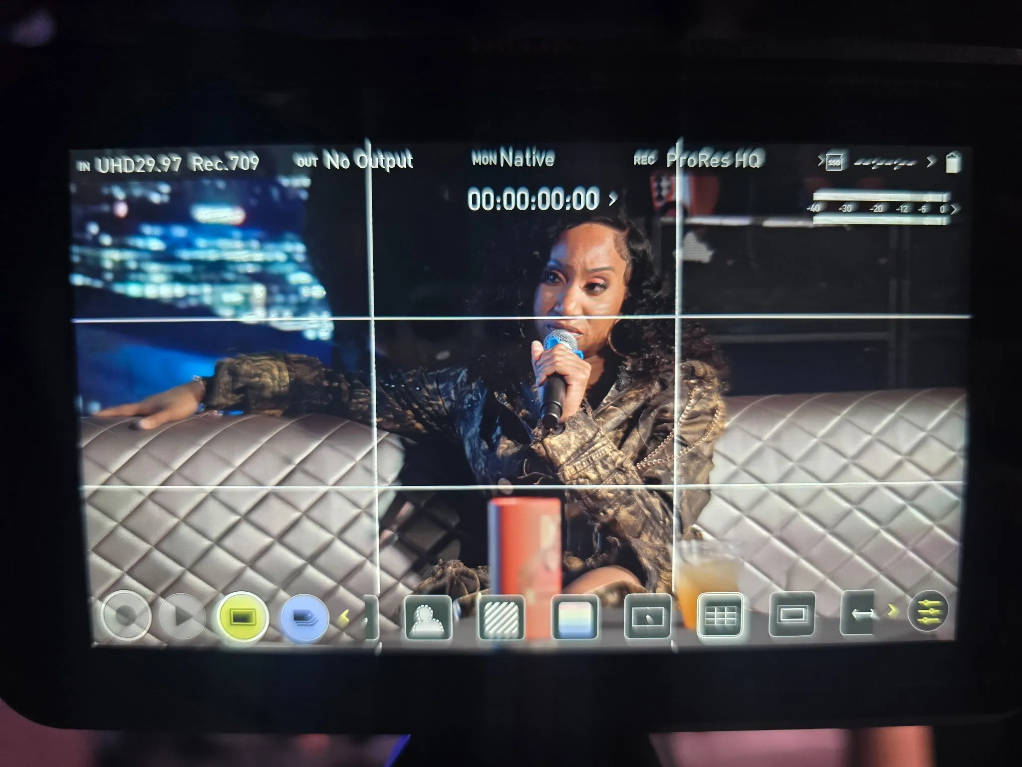 Monitor view of an interview subject speaking into a microphone